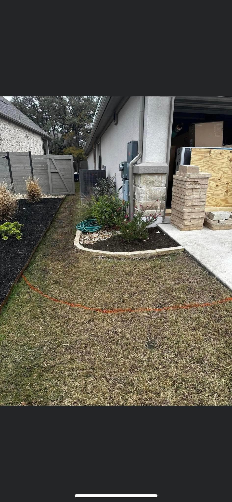 Side yard before renovation, bare dirt path along the house